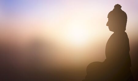 Buddhist concept: Buddha statue on the background of the sunsetの写真素材