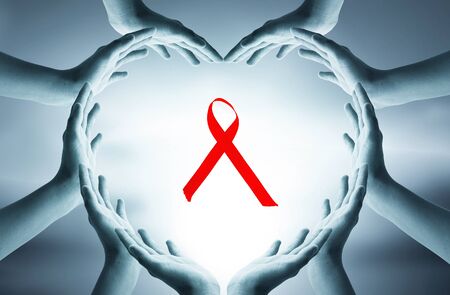 World AIDS Day concept: hands forming a heart with a red ribbonの写真素材