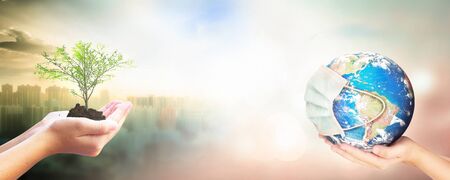 Earth Day concept: Corona virus or COVID-19 Earth wearing a mask.の写真素材