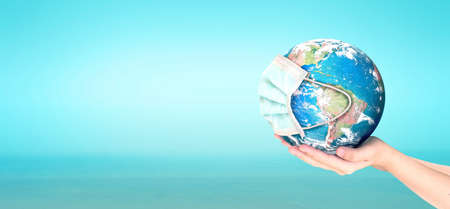 Earth is wearing protection mask on nature blurred background ,の写真素材