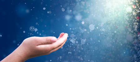 Christmas concept: pray hand on Abstract christmas lights backgroundの写真素材