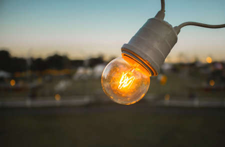Vintage lighting Bulb decor , Incandescent Lamp Retro style in sunset background