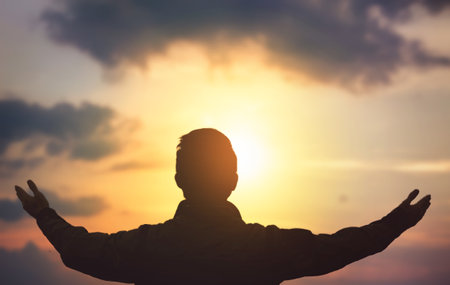 man rise hand up on top of mountain and sunset sky abstract backgroundの写真素材