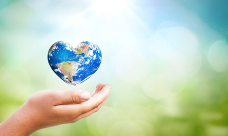 ESG concept: Human hands holding the earth against a green and ecological sustainability backgroundの写真素材