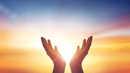 Human hands open palm up worship at sunset Sky backgroundの写真素材