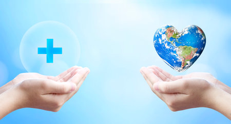 World Health Day, hold virtual plus medical network connection icons and Earth in heart shape on blue background.の写真素材