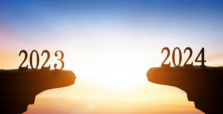 New Year 2024 and 2023 on on the mountain at sunset background