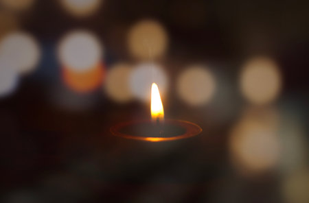 peace concept, burning candle on dark tableの写真素材