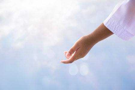 Jesus Christ with open arms reaching out to help in the skyの写真素材