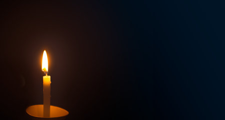 Burning candle on a dark background. Copy space for text.の写真素材