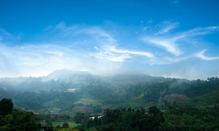 Beautiful mountains and villages against a sunny and blue skyの写真素材