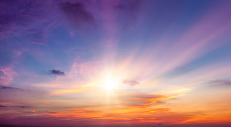 Beautiful sunset sky background with tiny clouds and rays of light.の写真素材
