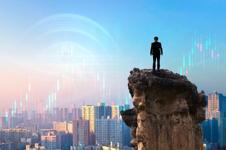 Businessman standing on edge of cliff over cityscape and forex chartの写真素材