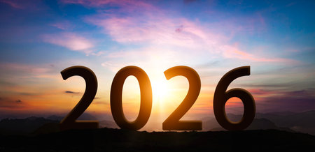 New Year 2026 at sunset. Silhouette 2026 stands on a mountain with sun rays at sunrise, creative idea. Year 2026, conceptの写真素材