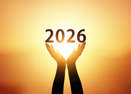 Silhouette of hands holding the number 2026 on sunset background.の写真素材