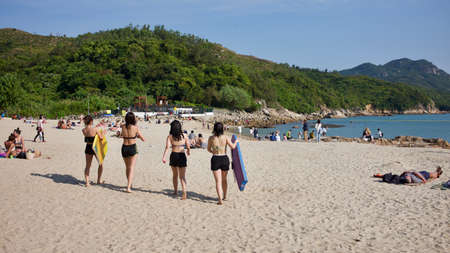 Lamma Island, Hong Kong - 12 April 2020 : Weekend travel capture, people enjoying the sunlight at the Hung Shing Yeh Beach at the island.のeditorial素材