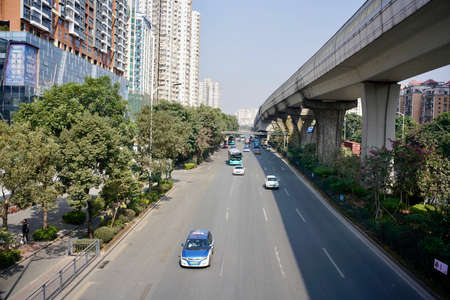 Shenzhen, Guangdong Province, China - 28 December 2019: Landscape of the road in town with some cars moving.のeditorial素材