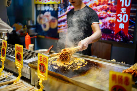 Shenzhen, Guangdong Province, China - 28 December 2019: Local food stall selling snacks and features...