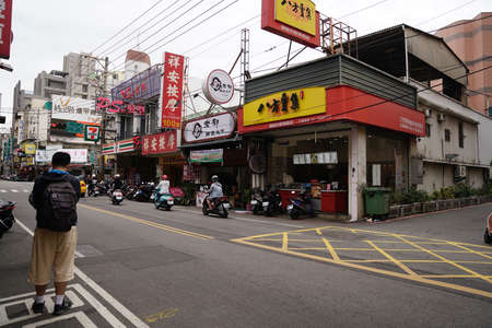 Taichung, Taiwan - 2 November 2018: Cityscape of the town, capturing street with buildings near road.のeditorial素材