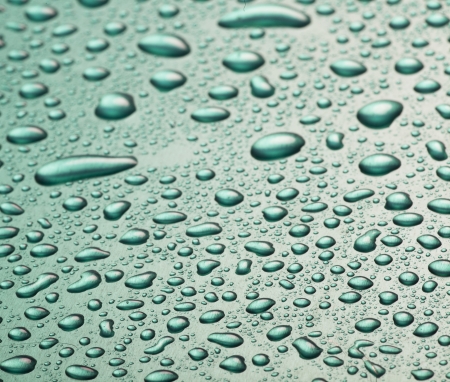 Drops of water in the metal plateの写真素材