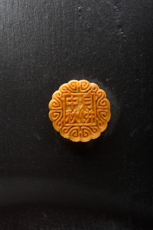 Chinese moon cake on a black backgroundの写真素材