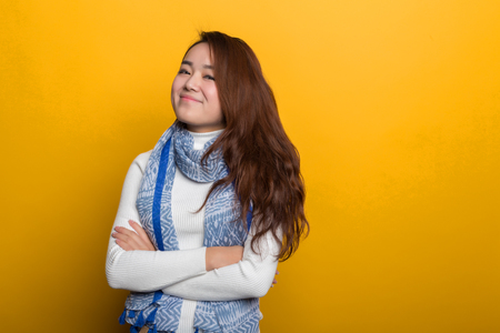 Young Chinese girl, various expressions on a yellow backgroundの写真素材
