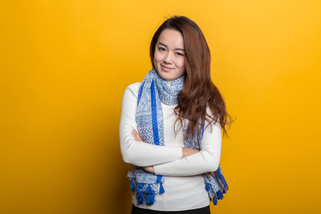 Young Chinese girl, various expressions on a yellow backgroundの写真素材