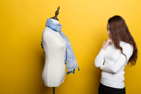 Chinese female designers in front of a yellow background, show themselvesの写真素材