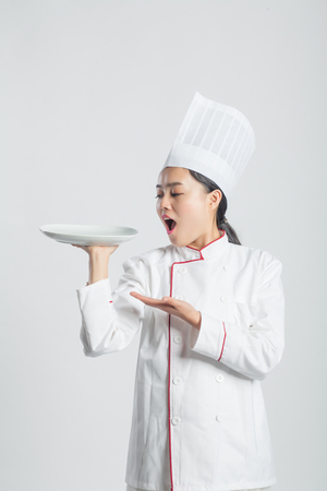 White Background, Chinese Girl Wearing Chef Dress Up Making Various Expressions, Asian Style People Seriesの写真素材