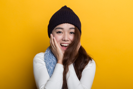 Young Chinese girl, various expressions on a yellow backgroundの写真素材