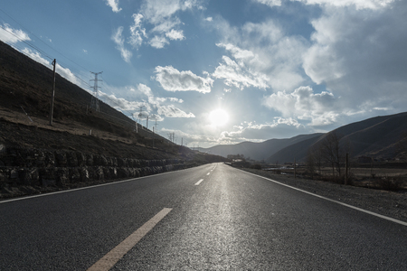 China Tibet Plateau, outdoor road. Backlit landscape, roadside power towerの写真素材
