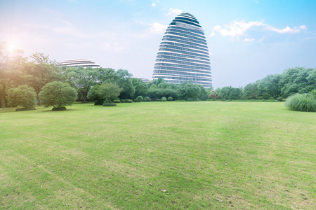 City park lawn, far away with modern architectureのeditorial素材