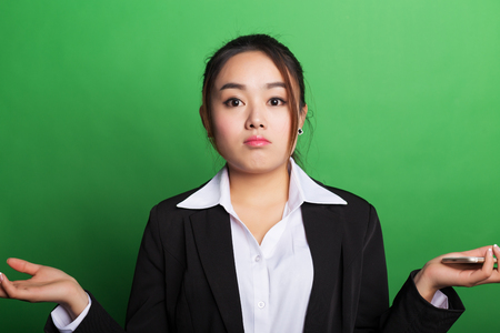 Chinese woman in formal attire with a green backgroundの写真素材