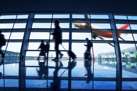 modern airport lobby with busy travelersの写真素材