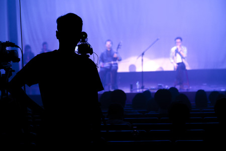 The stage is being performed on the stage in the theater, and the photographer records the show on...
