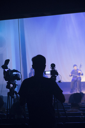 The stage is being performed on the stage in the theater, and the photographer records the show on...