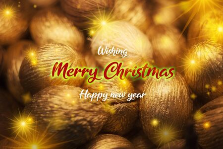 Christmas greeting card, dried seeds made into golden Christmas ornamentsの写真素材