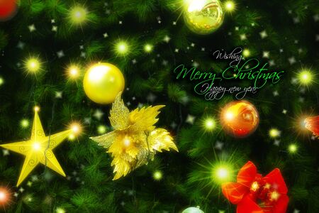 Christmas tree decorated with many Christmas ornaments, red bows and starsの写真素材