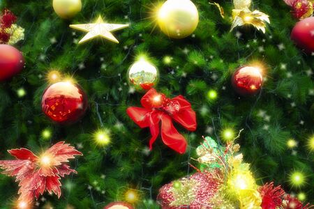 Christmas tree decorated with many Christmas ornaments, red bows and starsの写真素材