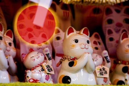 "Japanese lucky cat made a greeting card with the red sun as a symbol (Japanese: Lucky Cat Chinese: Peace, lucky blessing, good luck, good fortune, ten thousand)"の写真素材