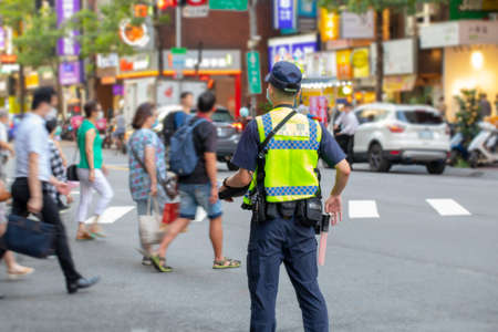 The police patrolling at the crossroads to guard the safety of the peopleの写真素材