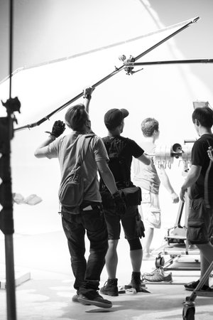 The lighting engineer in the studio is adjusting the lights in the sceneの写真素材
