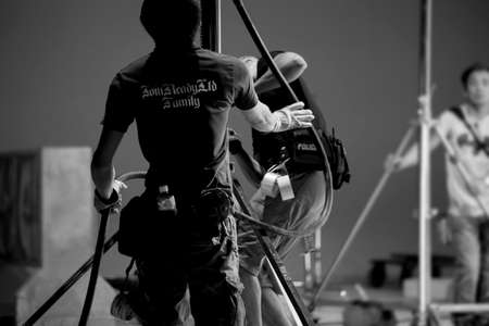 The lighting engineer in the studio is adjusting the lights in the sceneの写真素材