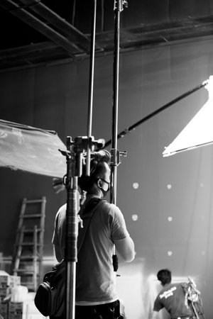 The lighting engineer in the studio is adjusting the lights in the sceneの写真素材