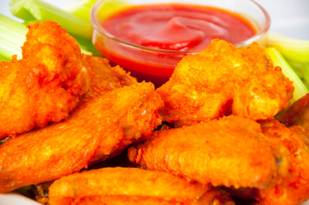 Delicious and delicious chipotle chicken wings on a white plateの写真素材