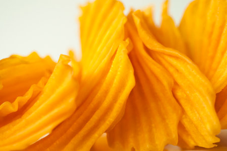 Closeup golden sweet potato chips on white backgroundの写真素材