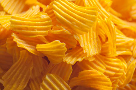 Closeup golden sweet potato chips on white backgroundの写真素材