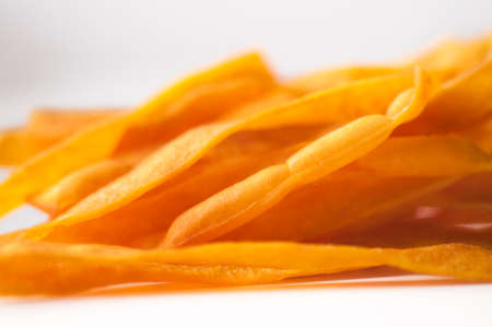 Closeup golden sweet potato fries on white background