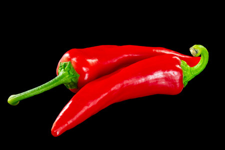 Red fresh bell peppers on black backgroundの写真素材