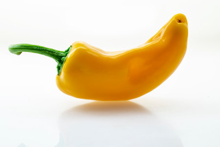 Yellow fresh bell peppers on a white backgroundの写真素材